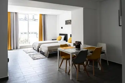 a bedroom with a bed and a table and chairs at Almada Downtown 304 in Porto