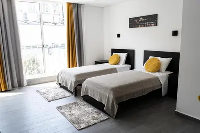 a bedroom with two beds and a large window at Almada Downtown 304 in Porto