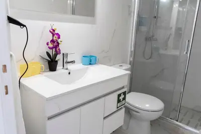 a bathroom with a sink and a toilet and a shower at Almada Downtown 401 in Porto
