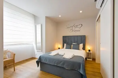a bedroom with a large bed with a blue blanket at APOSENTUS - Marta's House in Porto