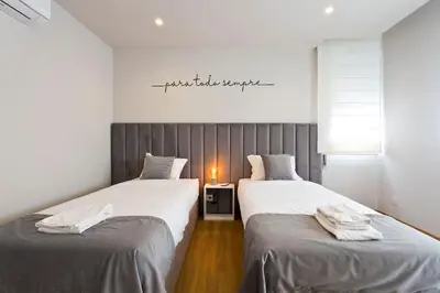 two beds sitting next to each other in a room at APOSENTUS - Marta's House in Porto