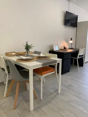 a white dining room table with chairs and a table at Almada Downtown 402 in Porto