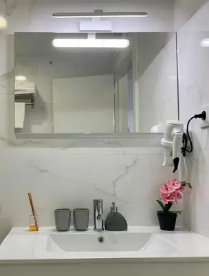 a bathroom sink with a large mirror above it at Almada Downtown 402 in Porto