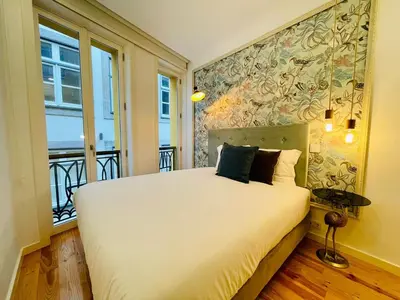 a bedroom with a large white bed with a window at Oporto Chic & Cozy - Mercadores in Porto
