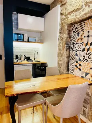 a kitchen with a wooden table and chairs at Oporto Chic & Cozy - Mercadores in Porto