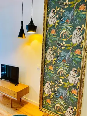a mirror in a room with a table and a tv at Oporto Chic & Cozy - Mercadores in Porto