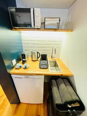 a small kitchen with a sink and a microwave at Oporto Chic & Cozy - Mercadores in Porto