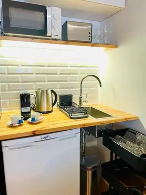 a kitchen counter with a sink and a microwave at Oporto Chic & Cozy - Mercadores in Porto