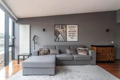 a living room with a gray couch and a table at MY DOURO VIEW Stunning Apartment River Front in Vila Nova de Gaia
