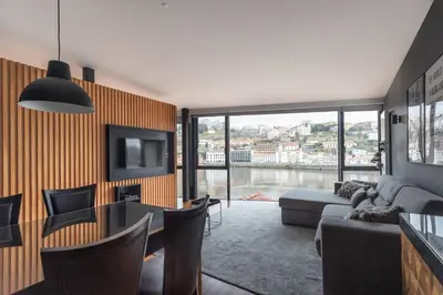 a living room with a couch and a tv at MY DOURO VIEW Stunning Apartment River Front in Vila Nova de Gaia