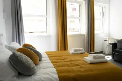 a bedroom with a bed with two towels on it at Almada Downtown 101 in Porto