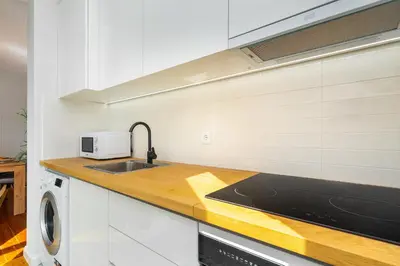 a kitchen with a sink and a microwave at Whome Formosa #2 - Central 2-Bed in Prime Location Perfect to Explore Porto in Porto