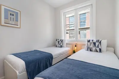 two beds in a small room with two windows at Whome Formosa #2 - Central 2-Bed in Prime Location Perfect to Explore Porto in Porto