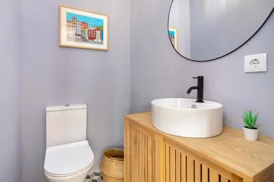 a bathroom with a sink and a toilet and a mirror at Whome Formosa #2 - Central 2-Bed in Prime Location Perfect to Explore Porto in Porto