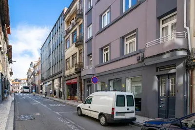 a white van parked on a city street with buildings at Whome Formosa #2 - Central 2-Bed in Prime Location Perfect to Explore Porto in Porto