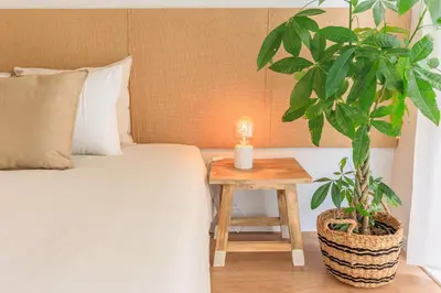 a bedroom with a bed and a table with a plant at Enjoy Bonfim Central 2BR Renovated Apartment by LovelyStay in Porto