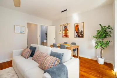 a living room with a white couch and a table at Whome Formosa #3 - Central 2-Bed in Prime Location Perfect to Explore Porto in Porto