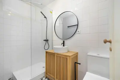 a bathroom with a mirror and a sink and a tub at Whome Formosa #3 - Central 2-Bed in Prime Location Perfect to Explore Porto in Porto
