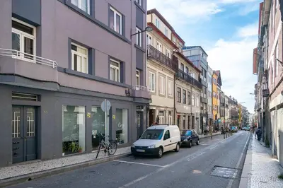 a white van parked on a city street with buildings at Whome Formosa #3 - Central 2-Bed in Prime Location Perfect to Explore Porto in Porto