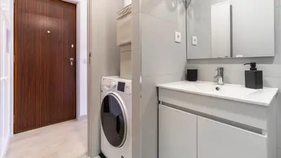 a kitchen with a washing machine and a sink at Delightful Bombarda Apartment by Unique Hosts in Porto