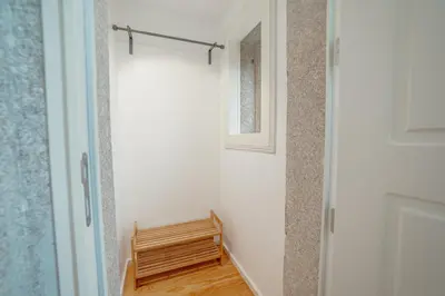 a hallway with a wooden bench and a mirror at Downtown Premium Apartment by Vacationy in Porto