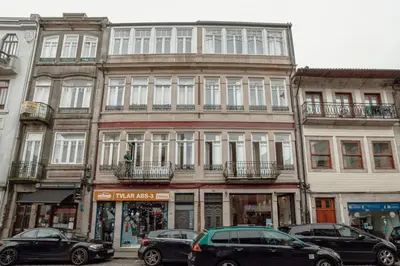 a tall building with cars parked in front of it at Downtown Premium Apartment by Vacationy in Porto