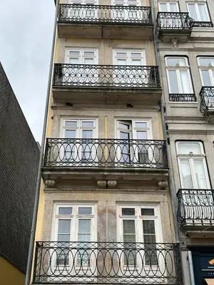 a tall building with balconies on the side of it at Oporto Chic & Cozy Cardosas in Porto