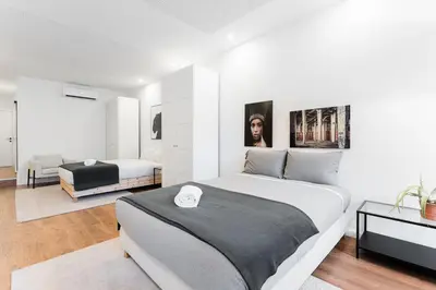 a bedroom with a large bed and a living room at GuestReady - Uptown suites in Porto