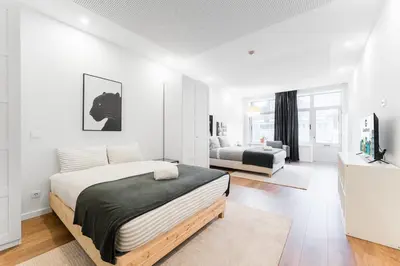 a bedroom with a bed and a living room at GuestReady - Uptown suites in Porto
