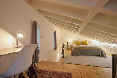 a bedroom with a bed and a table and a desk at Maison214 in Vila Nova de Gaia