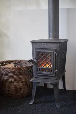 a black stove sitting next to a basket at Maison214 in Vila Nova de Gaia