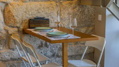 a table with two glasses of wine on it at Aposentus - Stylish Downtown Loft in Porto