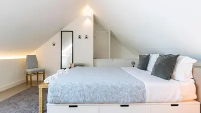 a bedroom with a king sized bed in a attic at Aposentus - Stylish Downtown Loft in Porto
