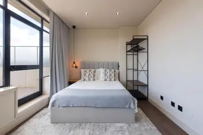a bedroom with a bed with white sheets and pillows at DOISPONTOZERO Júlio Dinis in Porto