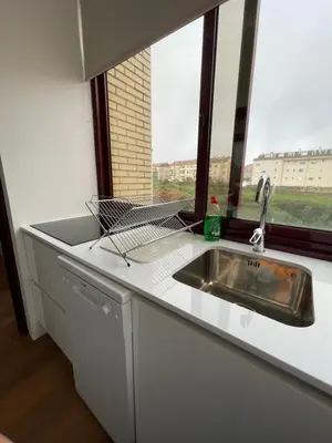 a kitchen counter with a sink and a window at Lindo apartamento em Gaia ao lado Bodegas in Vila Nova de Gaia