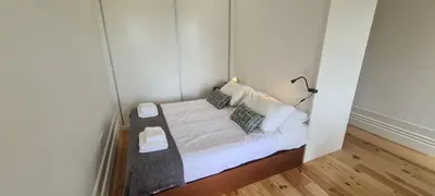 a small bedroom with a bed in a room at Merc Porto Estudio 245 in Porto