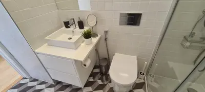 a bathroom with a toilet and a sink and a shower at Merc Porto Estudio 245 in Porto