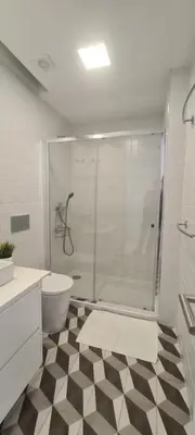 a bathroom with a shower and a toilet and a sink at Merc Porto Estudio 245 in Porto
