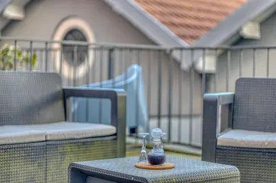 a glass bottle sitting on a table on a patio at Formosa Patio with Free Parking in Porto