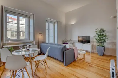 a living room with a couch and a table at Formosa Patio with Free Parking in Porto