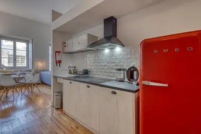 a kitchen with a red refrigerator in a room at Formosa Patio with Free Parking in Porto
