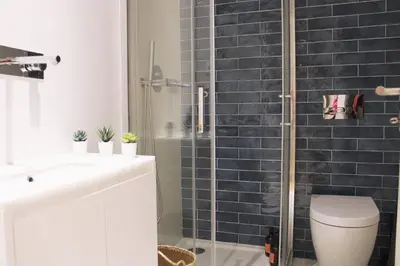 a bathroom with a shower and a toilet and a sink at Artistic Neighborhood Luxury in Porto