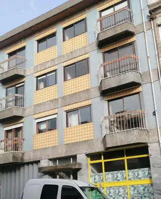 a building with balconies and a van parked in front of it at Porto Grand Sasimi House in Porto
