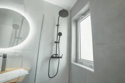 a shower in a bathroom with a window at Crystal Palace Garden Stylish Apartment by Vacationy in Porto