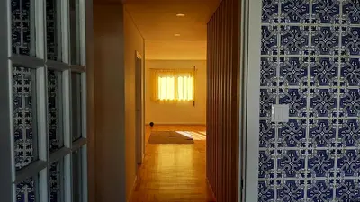 a bedroom with a large bed with two lamps on it at taol in Vila Nova de Gaia