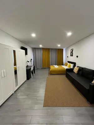 a living room with a couch and a bed at Almada Downtown 102 in Porto