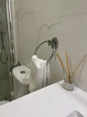 a bathroom with a toilet and a towel at Almada Downtown 102 in Porto