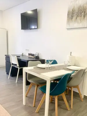 a dining room with a white table and chairs at Almada Downtown 103 in Porto