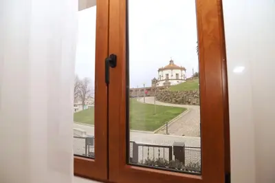 an open window with a view of a building at Casa do Pilar - D. Luís I in Vila Nova de Gaia