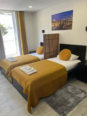 two beds sitting next to each other in a room at Almada Downtown 104 in Porto